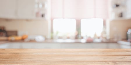 Well lit clean kitchen with a wood island